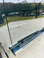2010 GMC Sierra Denali 1500 side view with chrome lettering, showcasing a clean exterior and running boards.