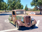 1936 Ford Truck with unique patina and bullet holes parked in a scenic area