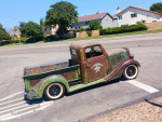 1936 Ford pickup truck 'La Cucaracha' with unique patina, parked on the street, showcasing classic design.