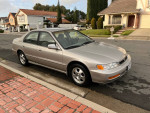 1997 Honda Accord Special Edition parked on the street, showcasing its clean exterior and smooth design.