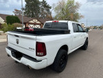 2013 Ram 1500 Sport 4WD truck with black wheels parked on residential street, showcasing clean exterior and rear view.