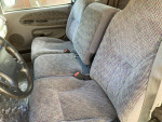 Interior view of a 1998 Dodge Ram 1500 with gray fabric seats and steering wheel.