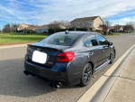 2018 Subaru WRX with grey exterior parked on the street, showcasing rear view and sporty design.