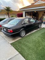 Black 2001 BMW 530i parked outside, showing good body condition and recent upgrades, ready for engine repair.