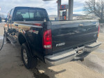 1999 Ford F-350 Super Duty parked at a gas station, showing rear and side view, 4x4, for sale at $2,600 cash.
