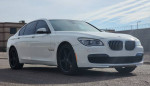 2013 BMW 740i M Sport Twin Turbo in white, showcasing sleek design and stylish rims.