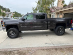 2015 Chevrolet Silverado 1500 LT 4WD, black truck with 6-inch lift and Falken tires, parked outdoors.