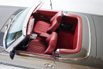 Interior view of a 1989 Mercedes-Benz 560SL with red leather seats and pristine condition.