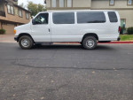 2004 Ford E-350 15 passenger van in excellent condition, featuring new tires and a clean interior.