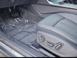 Interior view of a 2019 Audi A7 showing the driver's seat and floor with protective covering.