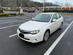 2011 Subaru Impreza with AWD, heated seats, and sunroof parked in a shopping area.