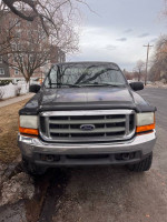 Front view of a 1999 Ford F350 Super Duty with 83,000 miles, a solid project truck ready for restoration.