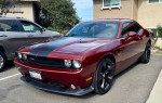 2014 Dodge Challenger SXT 100th Anniversary Edition in near mint condition, red with black accents, parked in a residential area.