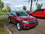 2012 Volkswagen Tiguan S 4Motion AWD in red, parked outdoors, showing clean exterior and new tires.