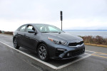 2019 Kia Forte in excellent condition parked by the waterfront, showcasing its sleek design and modern features.