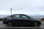 2019 Kia Forte in excellent condition, parked by the seaside, showcasing its sleek design and smooth lines.