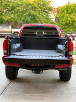 Back view of 2019 Toyota Tacoma TRD Off Road 4WD with long bed and upgrades, parked in residential area.