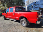 Red 2002 Ford F250 Superduty XLT Crew parked, showcasing its features and well-maintained condition.