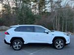 Side view of a 2022 Toyota RAV4 Prime SE in white, showcasing its immaculate condition and modern design.