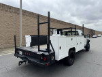 2009 Ford F450 utility bed work truck with low mileage parked on the street