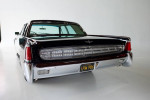 Rear view of a restored 1963 Lincoln Sedan in pristine condition, showcasing classic design and chrome accents.