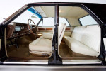 Interior of a pristine 1963 Lincoln Sedan showcasing its original white upholstery and classic design.