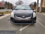 Front view of a 2010 Nissan Sentra SL parked, showcasing its sleek design and clean appearance.