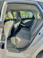 Interior view of a 2015 Toyota Prius with spacious back seat and gray upholstery.