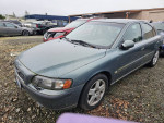 2002 Volvo S60 2.4 Sedan parked at repair shop with 132,000 miles, in good condition despite being dusty.