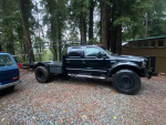 2000 F550 4x4 truck with 7.3 engine, 41-inch tires, in a forest setting, available for sale in California.