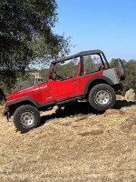 1994 Jeep Wrangler offroading with lifted suspension on rocky terrain, ready for adventure