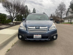 Front view of a 2013 Subaru Outback 2.5i AWD in blue, showcasing clean design and manual transmission.