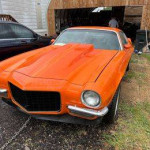 1970 Chevrolet Camaro Z-28 in bright orange, showcasing classic design and powerful stance with a rebuilt engine.