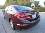 2014 Honda Civic LX sedan in excellent condition with 94k miles, clean title, parked on street with foliage in background.