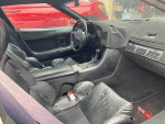 Interior view of 1990 Chevrolet Corvette featuring black leather seats and modern dashboard.