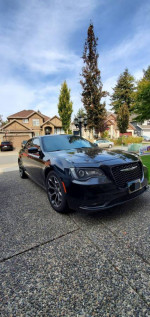 2016 Chrysler 300S in black, fully loaded with alloy wheels parked in a driveway