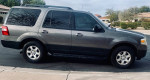 2014 Ford Expedition 4x4 in excellent condition, showcasing third row seats and low mileage of 127,000 mi for sale.
