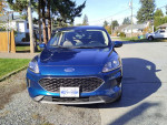 Front view of a blue 2020 Ford Escape SE with 91,000 miles parked on a driveway.