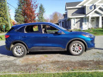 2020 Ford Escape SE FWD in blue parked outdoors, showcasing its sleek design and modern features.