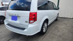 Rear view of a 2014 Dodge Grand Caravan with low mileage, showing its clean exterior and spacious design.