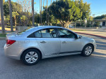 2016 Chevrolet Cruze LS in silver exterior parked, showcasing a clean and accident-free design.