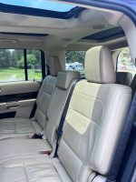 Interior view of a 2014 Ford Flex SEL showing spacious leather seating for seven passengers and sunroof.