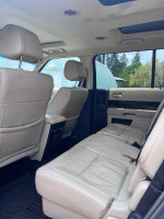 Interior view of a 2014 Ford Flex SEL showing spacious seating and leather upholstery for comfort.