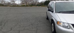 2006 Chrysler Town and Country van in silver, parked in an empty lot.