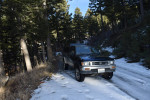 1993 Toyota Pickup in the woods with snow, showcasing its reliable 4WD and clean frame.