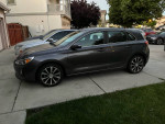 2018 Hyundai Elantra GT in gray color parked in a driveway, featuring 17-inch alloy wheels.