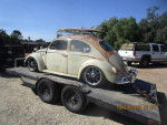 1963 VW Bug with patina paint job on a trailer, showcasing classic car features