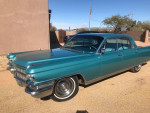 1963 Cadillac Fleetwood in turquoise, showcasing classic American luxury with sleek design and clean interior.