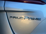 Close-up of the 2021 Toyota Prius Prime badge showcasing its hybrid technology.