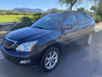 2009 Lexus RX 350 SUV in black, showcasing a clean exterior and a scenic background.